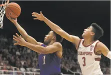  ?? Jeff Chiu / Associated Press ?? Devon Dotson beats Stanford’s Tyrell Terry in the second half. Dotson had 14 points and four of Kansas’ nine steals.