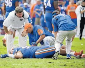  ?? JOHN RAOUX/ASSOCIATED PRESS ?? Gators coach Jim McElwain, left, might be without star defensive lineman Jon Bullard when UF faces rival FSU after the senior hurt his knee Saturday against Florida Atlantic.