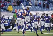  ?? ADRIAN KRAUS — THE ASSOCIATED PRESS ?? The Bills’ Matt Milano (58), Josh Norman (29) and teammates celebrate after beating the Colts in their AFC wild-card playoff game on Saturday in Orchard Park, N.Y.