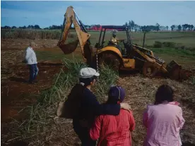  ?? Photograph: Nico Granada ?? Dr Rogelio Goiburú guides work at the dig while relatives of the disappeare­d and local residents look on.