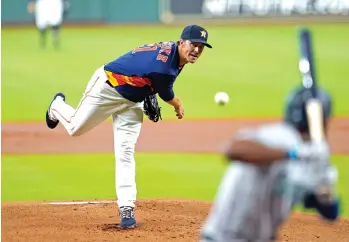  ?? David J. Phillip/Associated Press ?? ■ Houston Astros starting pitcher Zack Greinke, left, throws to Seattle Mariners' Kyle Lewis on Sunday in Houston.