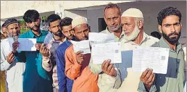  ?? ANI ?? People queue up to cast votes during the second phase of Lok Sabha polls; and (below) voters show inked fingers, in Jammu on Friday.