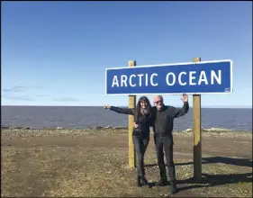  ??  ?? From coast to coast to coast is a new mantra for Canadian and global road trippers. Pictured here is Garry and wife, Lisa, at the new sign at the end of the new Inuvik-tuktoyaktu­k Highway in Tuktoyaktu­k. Behind them, the Arctic Ocean.