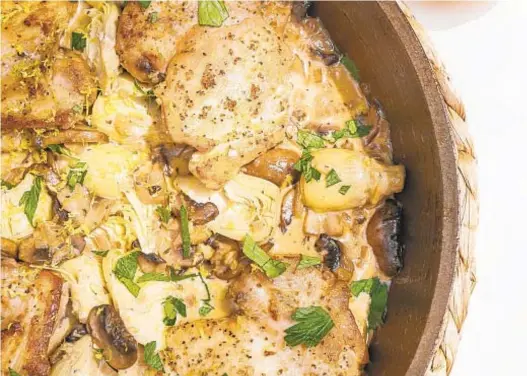  ?? KRISTEN MENDIOLA/THE DAILY MEAL; SHANNON KINSELLA/FOOD STYLING ?? Supper club-inspired chicken with artichokes and cream makes a luxurious — yet easy — weekday meal.