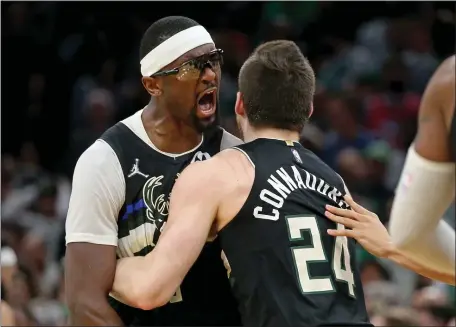  ?? STUART CAHILL / HERALD STAFF ?? TIPPING POINT: Milwaukee’s Bobby Portis screams after scoring the winning bucket on a putback of a missed free throw while getting a hug from Pat Connaughto­n in the Bucks’ 110-107 victory over the Celtics in Game 5 of the Eastern Conference semifinals Wednesday night at TD Garden.