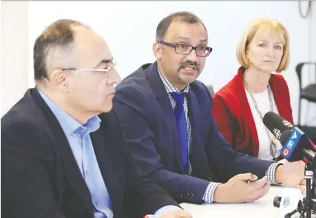  ?? NICK BRANCACCIO ?? Dr. Wajid Ahmed, centre, Windsor-essex County Health Unit medical officer of health, is joined by Onorio Colucci, left, CAO City of Windsor and Jan Wilson, the city’s executive director of recreation and culture, during COVID-19 update news conference at city hall Friday.