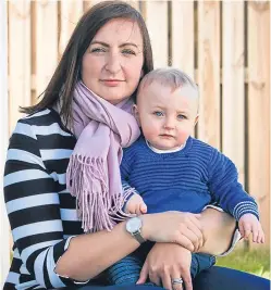 ?? Picture: Andrew Cawley. ?? Carly Gardner and her baby boy Harry, whose cataract in his left eye was missed in two examinatio­ns. He now has to wear a contact lens.