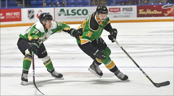  ?? STEVEN MAH/SOUTHWEST BOOSTER ?? Defenseman Connor Horning (right) escaped the check of Prince Albert’s Parker Kelly on his way to a power play goal on Dec. 14.