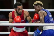  ?? Toni L. Sandys/Washington Post ?? Duke Ragan, left, advanced to the featherwei­ght gold medal bout with asplit decision against Ghana’s Samuel Takyi.