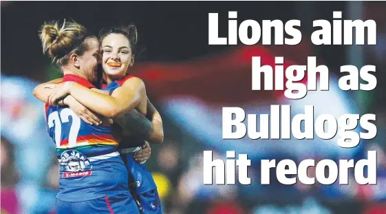  ?? Picture: GETTY IMAGES ?? Hannah Scott and Nicole Callinan celebrate the Bulldogs’ big win over Carlton last night.