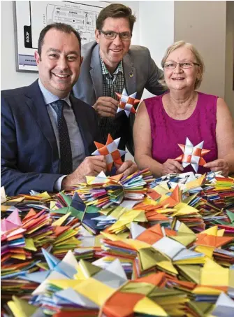  ?? PHOTO: NEV MADSEN ?? STARRY EYED: With some of the 25,000 stars made in the Darling Downs to end violence are (from left) Grand Central centre manager Shaine Beveridge, Cr Geoff McDonald and Sue Vaughan from Star Weave Fairies.