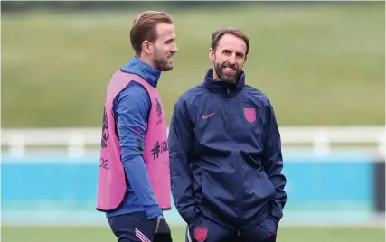  ??  ?? England boss Gareth Southgate chats to skipper Harry Kane during a training session at St George’s Park