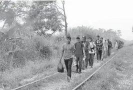  ?? ISABEL MATEOS/AP ?? Migrants from Central America seeking to reach the United States border walk along train tracks in Chiapas state in southern Mexico on Wednesday.