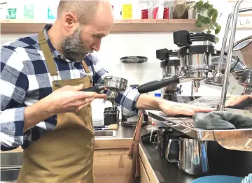  ??  ?? Shop owner Michele Carisi makes a drink at LABB Caffettin. — Washington Post photos by Chico Harlan