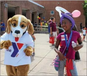  ?? DIGITAL FIRST MEDIA FILE PHOTO ?? MoniYah Pearson-Henderson, 12, dances alongside the YMCA mascot during the combined Pottstown Celebrates Young Children event and the YMCA Healthy Kids Day at the high school. The Philadelph­ia Freedom Valley YMCA has announced that it will close its...