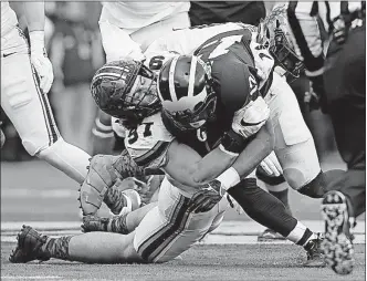  ?? [BARBARA J. PERENIC/DISPATCH] ?? Ohio State’s Nick Bosa tackles Michigan’s Chris Evans on Nov. 25. Bosa expects attention from extra blockers next season after graduation thins some of the line’s depth.