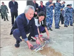  ?? GUO CHENG / XINHUA ?? Sea turtles are released on Yongxing Island in Sansha, Hainan province, at an event to promote environmen­tal protection.