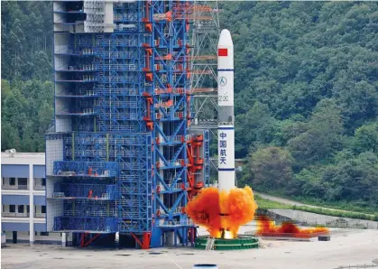  ?? Photo: IC ?? The Long March 2C carrier rocket manages to carry three satellites of Yaogan 30-05, a series of Chinese reconnaiss­ance satellites, to space and put them into orbit for the fifth time at Xichang Satellite Launch Centre, near Xichang city, Southwest China’s Sichuan province, July 26, 2019.