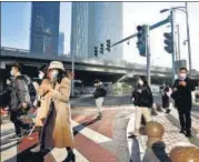  ?? REUTERS ?? People walk during morning rush hour, following the outbreak of Covid-19, in Chaoyang district, Beijing, on Monday.