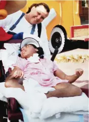  ?? Courtesy of Jamie Acebo ?? Jamie Acebo pushes her daughter Jasmine in her wheelchair during a trip to Islands of Adventure. Jasmine eventually outgrew her wheelchair and was mainly confined to a hospital bed in her room at home.