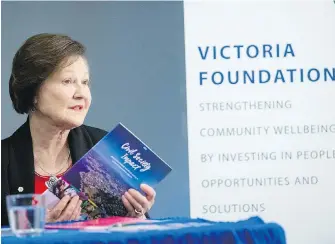  ??  ?? Victoria Foundation CEO Sandra Richardson displays a copy of the report Civil Society Impact at a press conference at the Victoria Social Innovation Centre on Tuesday.