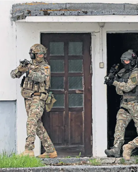  ?? ?? Nato troops, above, take part in a tactical exercise in the Lithuanian city of Klaipeda as part of Operation Flaming Sword, which is held annually to bolster co-ordination between allied forces