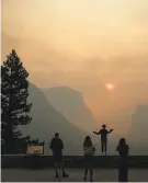  ?? Noah Berger / Associated Press ?? Hannah Whyatt poses as smoke from the Ferguson Fire fills Yosemite park.