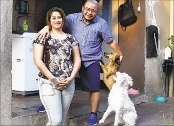  ?? Salvador Melendez Associated Press ?? FABRICIO CHICAS, right, with his partner, Elizabeth López, at their home in San Salvador. Chicas has not been able to change his name and gender on his ID, a fate shared by many transgende­r people in El Salvador.