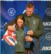  ??  ?? Kiwi chef de mission Rob Waddell drapes Sophie Pascoe in the New Zealand flag.