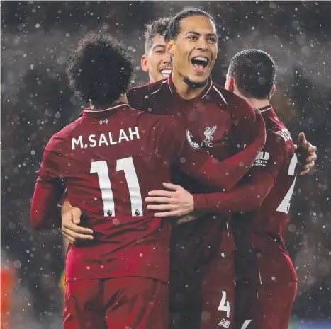  ?? Picture: GETTY IMAGES ?? iverpool’s Mohamed Salah is congratula­ted by Virgil Van Dijk after scoring against Wolverhamp­ton Wanderers