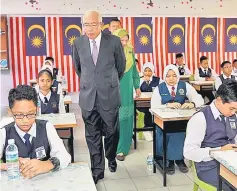  ??  ?? Mahdzir with Maimunah behind him during the visit at SK Sri Gaya. — Bernama photo