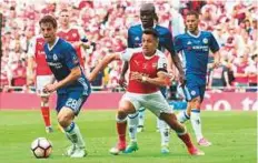  ?? Rex Features ?? Chilean forward Alexis Sanchez (centre) has a year left on his Gunners deal but is yet to sign a new contract and has been linked with a move to Bayern Munich and Manchester City. Sanchez is not on Arsenal’s pre-season tour to Australia.