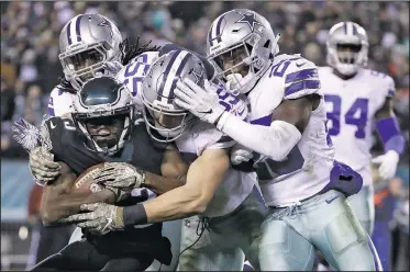  ?? AP/MATT ROURKE ?? Philadelph­ia Eagles wide receiver Nelson Agholor (bottom left) is tackled by Dallas Cowboys middle linebacker Jaylon Smith (top left) outside linebacker Leighton Vander Esch (center) and free safety Xavier Woods during the second half of an NFL football game Sunday in Philadelph­ia.