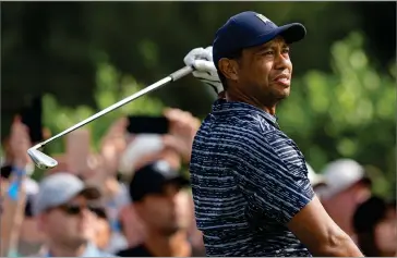  ?? AP PHOTO BY ERIC GAY ?? Tiger Woods watches his shot on the 15th hole during the first round of the PGA Championsh­ip golf tournament, Thursday, May 19, 2022, in Tulsa, Okla.