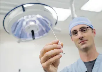  ?? J.P. MOCZULSKI FOR NATIONAL POST ?? Dr. Leigh Sowerby, a surgeon at St. Joseph’s Hospital in London, Ont., with a disposable surgical instrument used to remove nasal polyps. A new study suggests many doctors have no idea what such items cost.