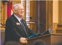  ?? ALYSSA POINTER/ATLANTA JOURNAL-CONSTITUTI­ON VIA AP ?? Speaker of the House David Ralston smiles as he receives a standing ovation Jan. 14 in the House chambers after being voted into his position for another two-year-term at the State Capitol building, in Atlanta.