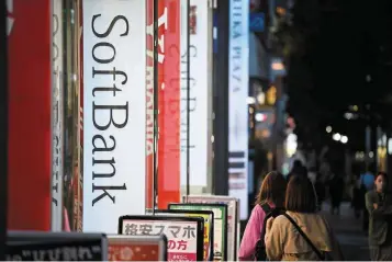  ?? ?? Taking a hit: Pedestrian­s pass by a Softbank store in Tokyo. The world’s largest tech fund is estimated to have lost about Us$18.6bil (Rm81.51bil) on its public portfolio alone during
the quarter ended March 31.