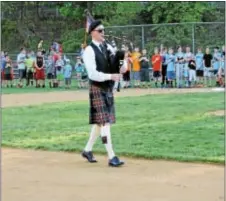  ?? LORETTA RODGERS — DIGITAL FIRST MEDIA ?? A lone bagpiper honored the memory of Rich Scharrer during a solemn ceremony at the Aston-Middletown Little League Friday Night.