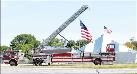  ?? Westside Eagle Observer/MIKE ECKELS ?? Fireworks are offered for sale in a number of locations in Gentry and Eagle Observer territory. This stand, at the corner of Arkansas Highways 12 and 59, flies the American flag from an antique hook and ladder fire truck.