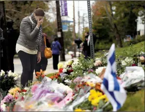  ?? AP/MATT ROURKE ?? A person mourns at a makeshift memorial at the Tree of Life Synagogue on Sunday in Pittsburgh.