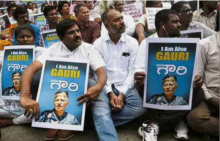  ??  ?? Cry for justice: Participan­ts holding placards and listening to a speaker at a demonstrat­ion against the killing of Lankesh in Bangalore. — AP