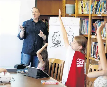  ?? Photograph­s by Kirk McKoy Los Angeles Times ?? AUTHOR DAV PILKEY meets with students at Overland Avenue Elementary School. His series has sold 70 million books worldwide.