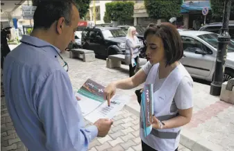  ?? Philip Issa / Associated Press ?? Candidate Laury Haytayan (right) speaks to a potential voter in Beirut’s Ashrafieh district. Haytayan is running for Parliament in Lebanon's first national elections in nine years.