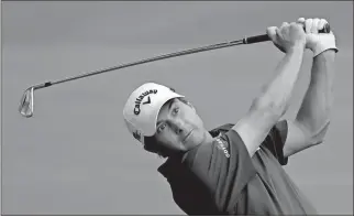  ??  ?? Kevin Kisner hits from the fairway on the 18th hole during the first round of the PGA Championsh­ip.