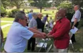  ?? ERIC DEVLIN — DIGITAL FIRST MEDIA ?? Ted Vogt, of Lower Pottsgrove, and John Foster of Douglassvi­lle, shake hands during a prayer service at First Presbyteri­an Church in Pottstown Sunday.