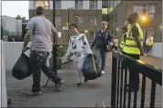  ?? ALASTAIR GRANT — THE ASSOCIATED PRESS ?? Residents are evacuated from the Taplow residentia­l tower block on the Chalcots Estate, in the borough of Camden, north London on Friday. A local London council has decided to evacuate some 800househo­lds because of safety concerns.