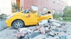  ??  ?? A damaged vehicle and debris caused by recent earthquake. — Reuters photo