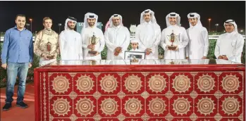  ??  ?? HE Sheikh Saoud bin Abdulrahma­n bin Hassan al Abdulrahma­n al Thani (centre), President of Qatar and Asian Equestrian Federation­s and QREC Vice-Chairman Hamad bin Abdulrahma­n al Attiyah (4th right) pose with the winners of Losail Cup after Molheb Al Naif won the 1200m race.