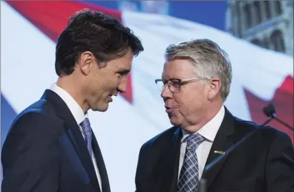  ?? GRAHAM HUGHES, THE CANADIAN PRESS ?? Prime Minister Justin Trudeau, left, talks with United Food and Commercial Workers union national president Paul Meinema Thursday.