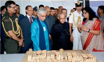  ?? — PTI ?? President Pranab Mukherjee examines a model of the Nalanda University campus at Rajgir, Nalanda, on Saturday. Mr Mukherjee, who laid the foundation stone for the 455- acre campus, said debates and free speech must be encouraged in universiti­es. He also...